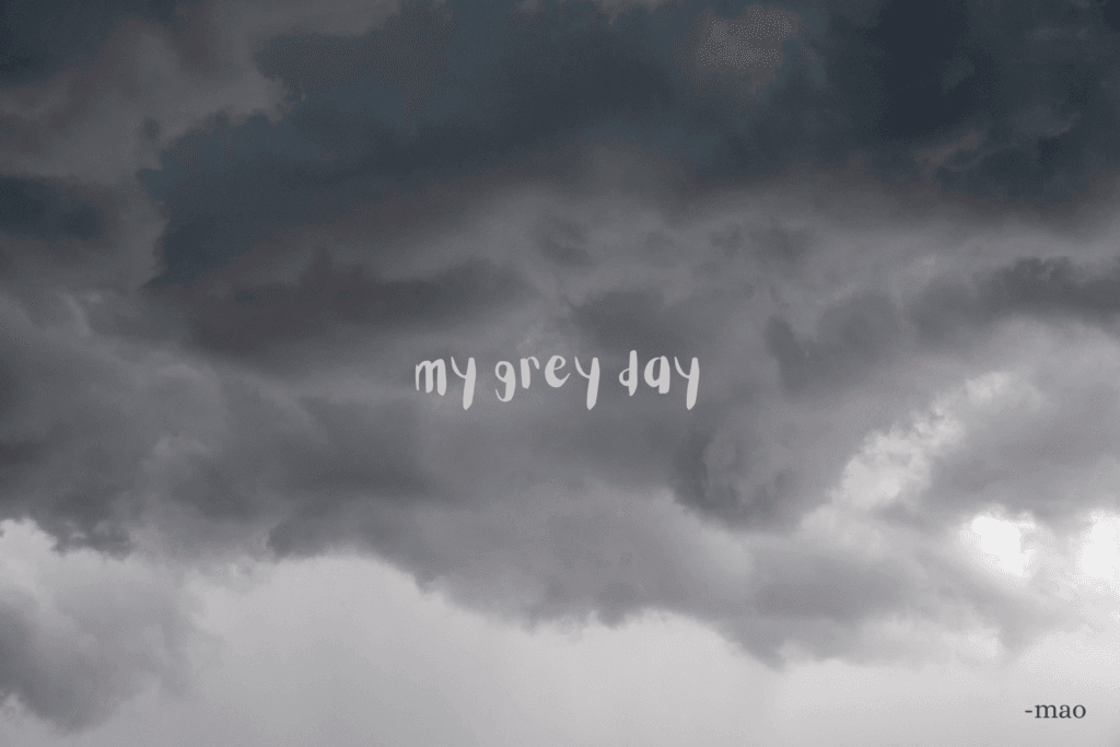 photo of dark grey clouds and the poem title 'my grey day' in the middle of image