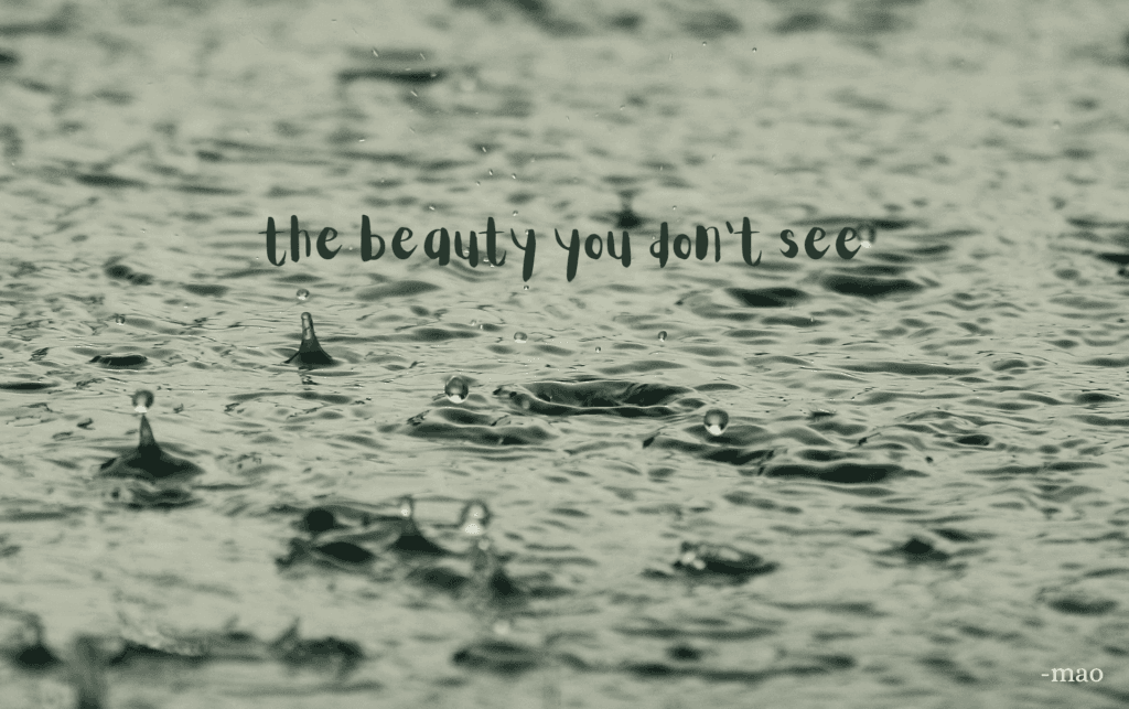 image on rain falling in water with poem title 'the beauty you don't see' in bold text