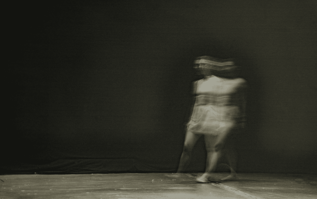 blurry black and white image of person walking