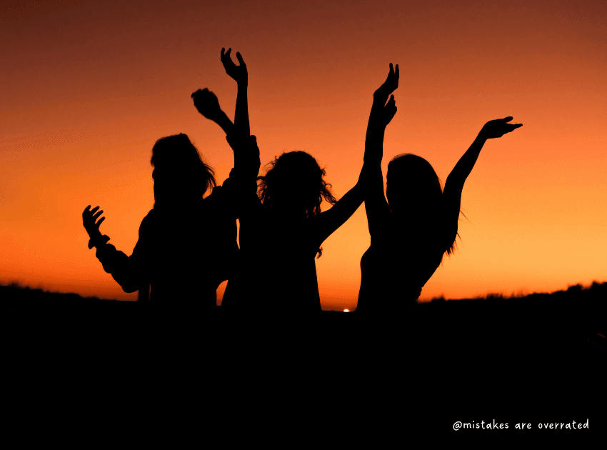 people celebrating achieving goals they set in life. silhouette of 3 ladies in front of sunset
