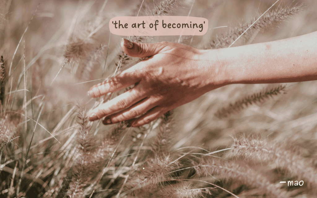open hand in a field with poem title 'the art of becoming' - mao